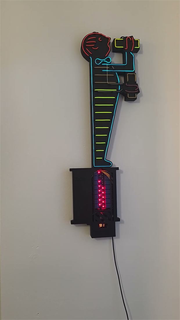 Wall sign shaped like a Cologne beer waiter, traced in coloured electroluminescent wire, above a black base with a red light strip.